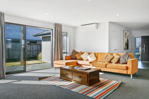 a living room with a couch and a coffee table at Huka Falls Getaway (Family escape) in Taupo
