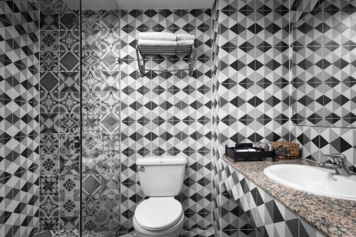 a bathroom with a toilet and a sink at Pacific Hotel in Phnom Penh