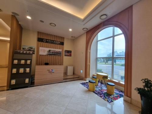 a lobby with a large window in a building at Island Castle Hotel & Waterpark in Uijeongbu