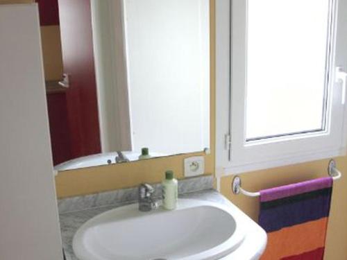 a bathroom with a white sink and a mirror at Mobil home confortable avec terrasse à Bretignolles-sur-Mer - API-1-52-656 in Brétignolles-sur-Mer
