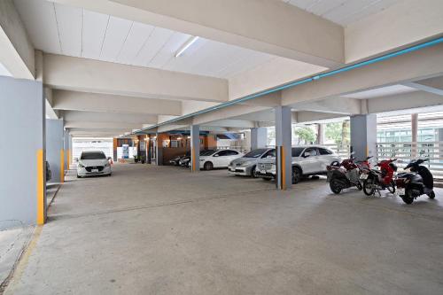 a parking garage with two motorcycles parked in it at P-Park Suvarnabhumi in Bangkok