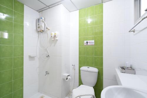 a bathroom with a shower and a toilet and a sink at P-Park Suvarnabhumi in Bangkok