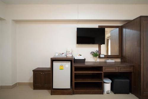 a kitchen with a desk and a small refrigerator at P-Park Suvarnabhumi in Bangkok