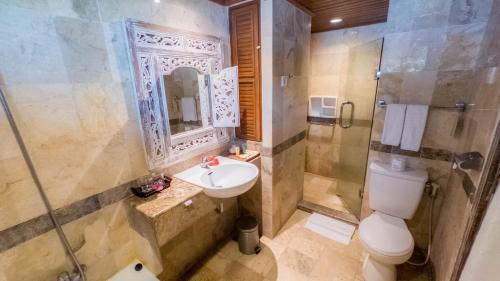 a bathroom with a sink and a shower and a toilet at Jayakarta Hotel Lombok in Senggigi 