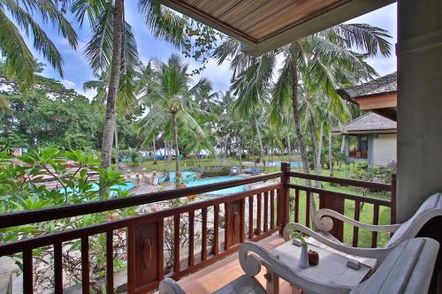 a balcony of a resort with a table and chairs at Jayakarta Hotel Lombok in Senggigi 