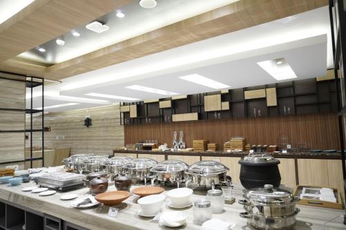 a kitchen with many pots and pans on a counter at Front One Hotel Papua Lestari in Timika