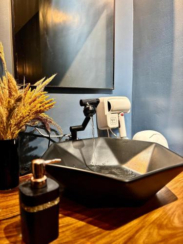 a bathroom sink with a faucet on a table at Balai Evelyn Homestay in Coron