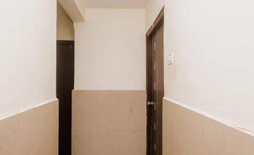 an open door in a room with white walls at Hotel O Diplomat in Sopāra