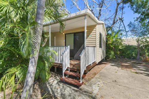 a tiny house with a porch and a porch swing at Ingenia Holidays Townsville in Townsville
