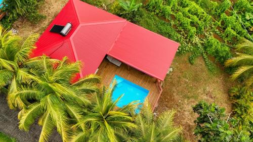 an overhead view of a house with a red roof at Villa Barthelemy - Gite 2 in Goyave