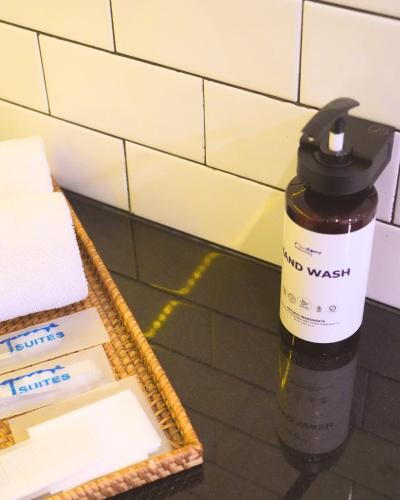 a bottle of hug wa wash sitting next to a mirror at Nagomi Suites & Hotel in Jakarta