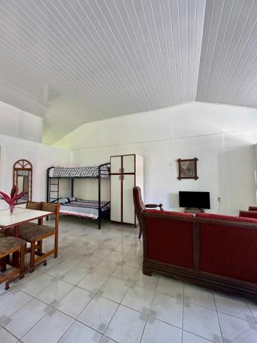 a living room with two bunk beds and a table at Villas Cozy Sloth in Puerto Viejo