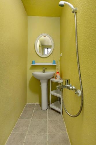 a bathroom with a sink and a mirror at Hill Side B&B in Yuchi