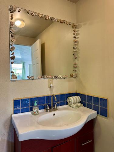 a bathroom with a sink and a mirror at Villas Cozy Sloth in Puerto Viejo