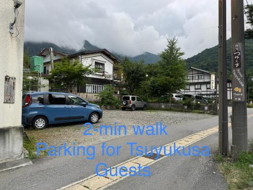 a blue car parked on the side of a street at Tsuyukusa in Takayama