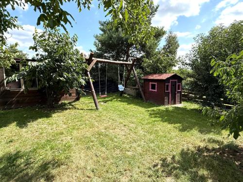 a playground in a yard with a swing at Chata Bruno v Kutné Hoře in Kutná Hora