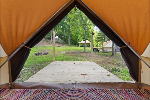 a view of a tent with a wooden floor inside at Glamping Yurt #1 in Red River Gorge, Wooded with Full Bath House in Stanton