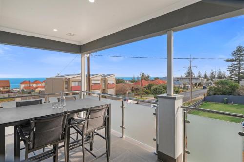 a view from the balcony of a house with a table and chairs at Ocean Views on Grundy I New Home I Family Friendly in Christies Beach