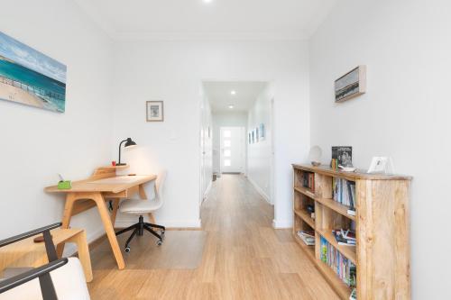 an office with a desk and a book shelf at Ocean Views on Grundy I New Home I Family Friendly in Christies Beach