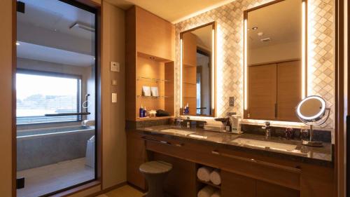 a bathroom with two sinks and a large mirror at Hotel Shion in Morioka