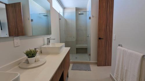 a bathroom with a sink and a mirror and a shower at Your Perfect Getaway in Vallarta, Pool & Balcony in Nuevo Vallarta