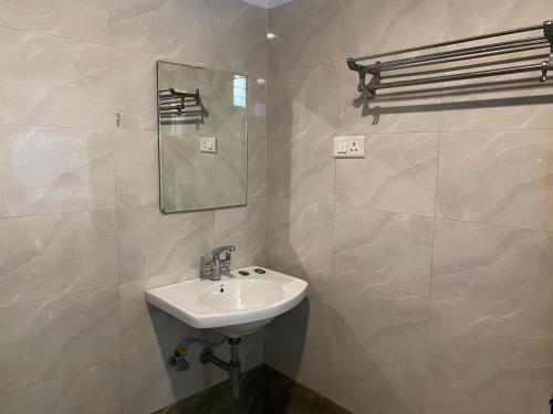 a bathroom with a sink and a mirror at Hotel Vacation in Jaipur