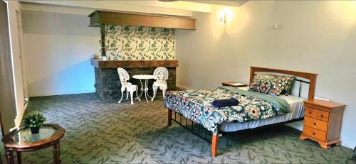 a bedroom with a bed and a fireplace at Retro Bar Themed Spacious Studio room in Perth