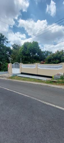 a white fence on the side of a road at Bromo Stay Hostel in Probolinggo
