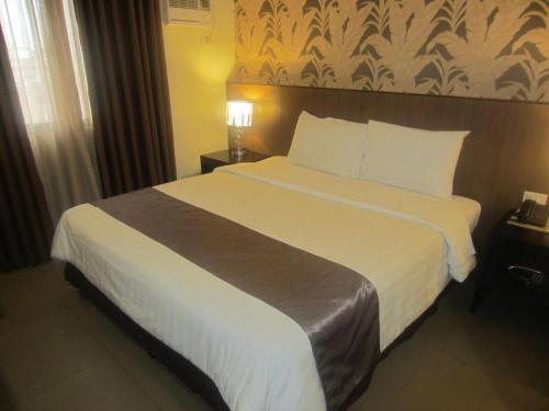 Кровать или кровати в номере GT Hotel Bacolod