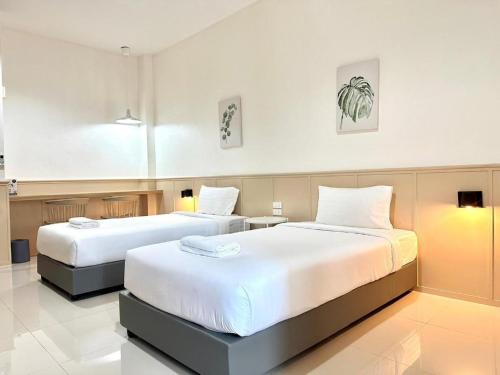 Postel nebo postele na pokoji v ubytování Grand PL Ville Hotel