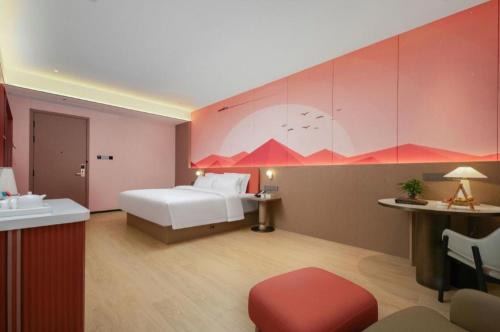 a bedroom with a bed and a sink in a room at Quanzhou Binhai Hotel in Quanzhou