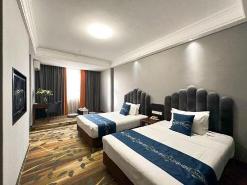 Dunhuang Dunhe Hotelにあるベッド