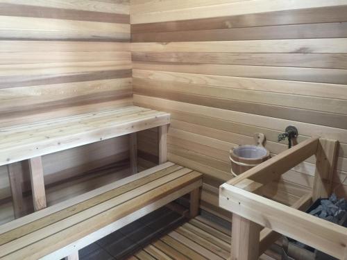 a sauna with wooden walls and wooden benches at Park Inn by Radisson Toronto-Markham in Markham