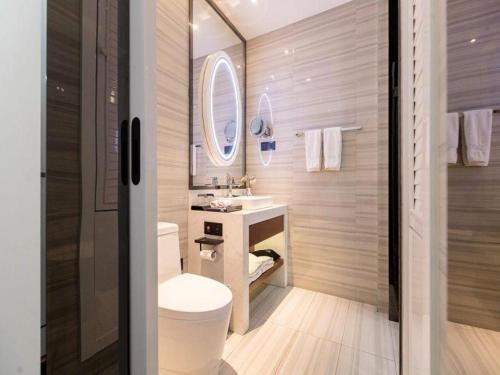 a bathroom with a sink and a toilet and a mirror at Xana Hotelle Xi'an GONG IP South Gate of Zhonglou in Xi'an
