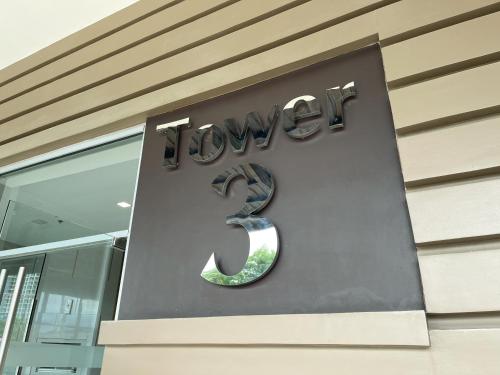 a sign on the side of a building with the number three at Cozy 2 Bedroom Condo with Balcony for Rent in Iloilo City