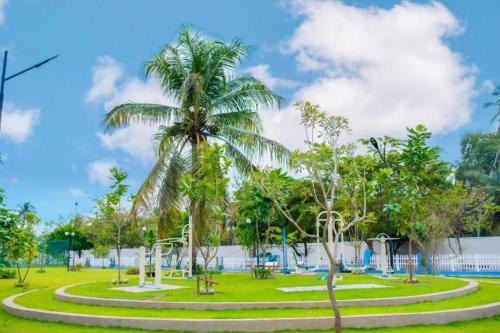 a park with palm trees and a pool at Santorini Blue Sapphire - Luxury 3BR Theme Park Resort Apartment - Negombo in Negombo