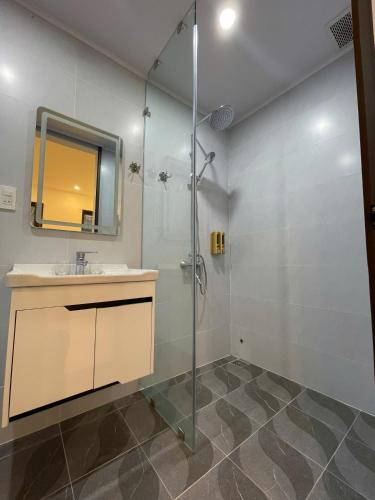 a bathroom with a shower and a sink and a mirror at Subin Homestay Hue in Thôn Kim Long (1)