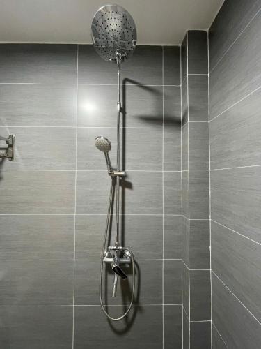 a shower with a shower head in a bathroom at Subin Homestay Hue in Thôn Kim Long (1)