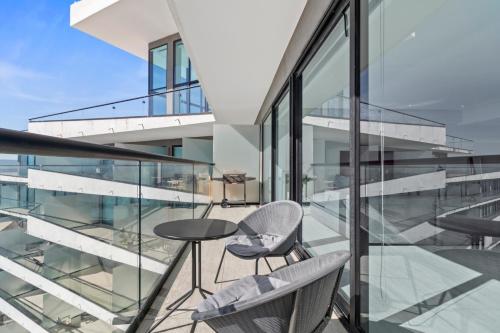 a balcony with a table and chairs on a building at Beachfront and modern getaway in Bucerías