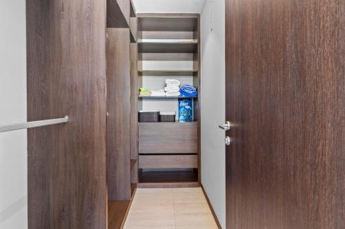 a hallway with a wooden door leading into a closet at Beachfront and modern getaway in Bucerías
