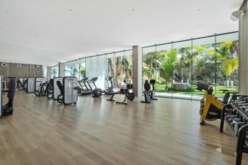 an empty gym with treadmills and elliptical machines at Beachfront and modern getaway in Bucerías
