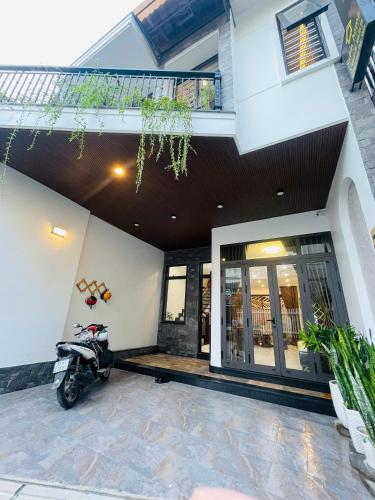 a motorcycle parked in front of a house at Subin Homestay Hue in Thôn Kim Long (1)