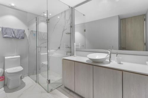 a bathroom with a toilet and a sink and a shower at Marina Vallarta with View and Pool in Puerto Vallarta