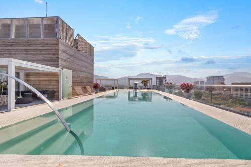 a swimming pool on the roof of a building at Marina Vallarta with View and Pool in Puerto Vallarta
