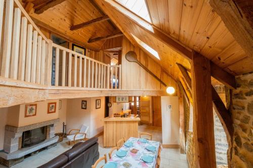 a large living room with a table and a fireplace at La grange in Les Salces
