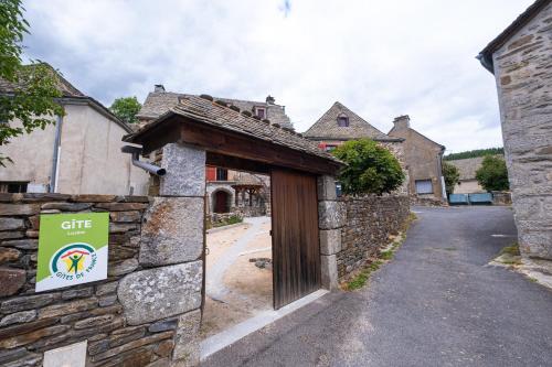 a entrance to a stone building with a sign on it at La grange in Les Salces