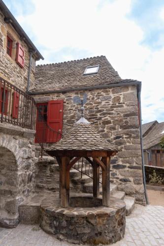 a stone building with a wooden table in front of it at La grange in Les Salces