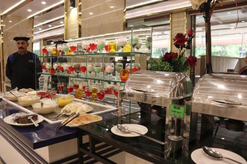 a buffet line with food on display in a restaurant at Islamabad Hotel in Islamabad