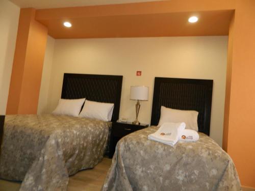 Postel nebo postele na pokoji v ubytování Hotel Plaza Bernal