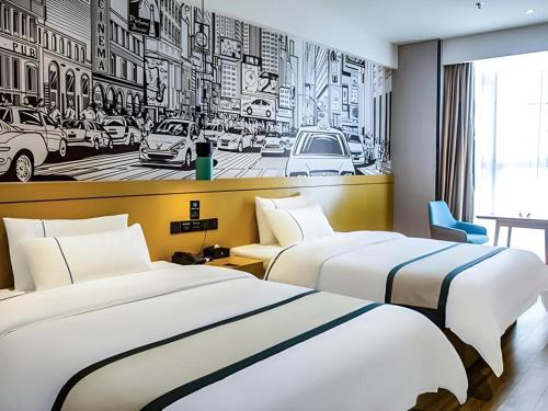due letti in una camera d'albergo con un letto bianco e nero di City Comfort Inn Liupanshui Sports Center a Shuicheng